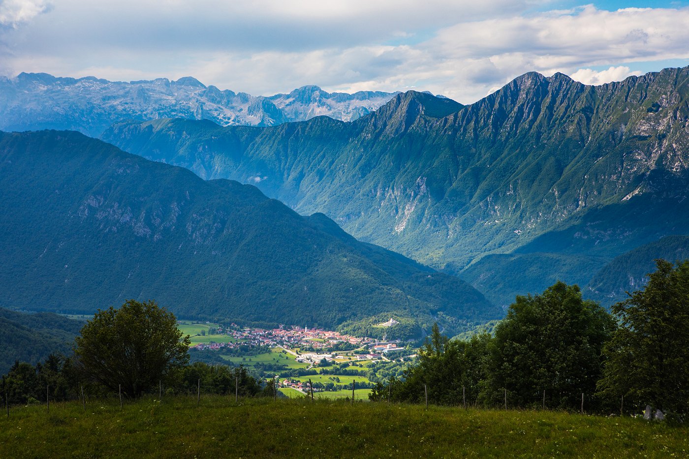 View of the town of Kobarid illuminated by the sun, in the background the local mountains