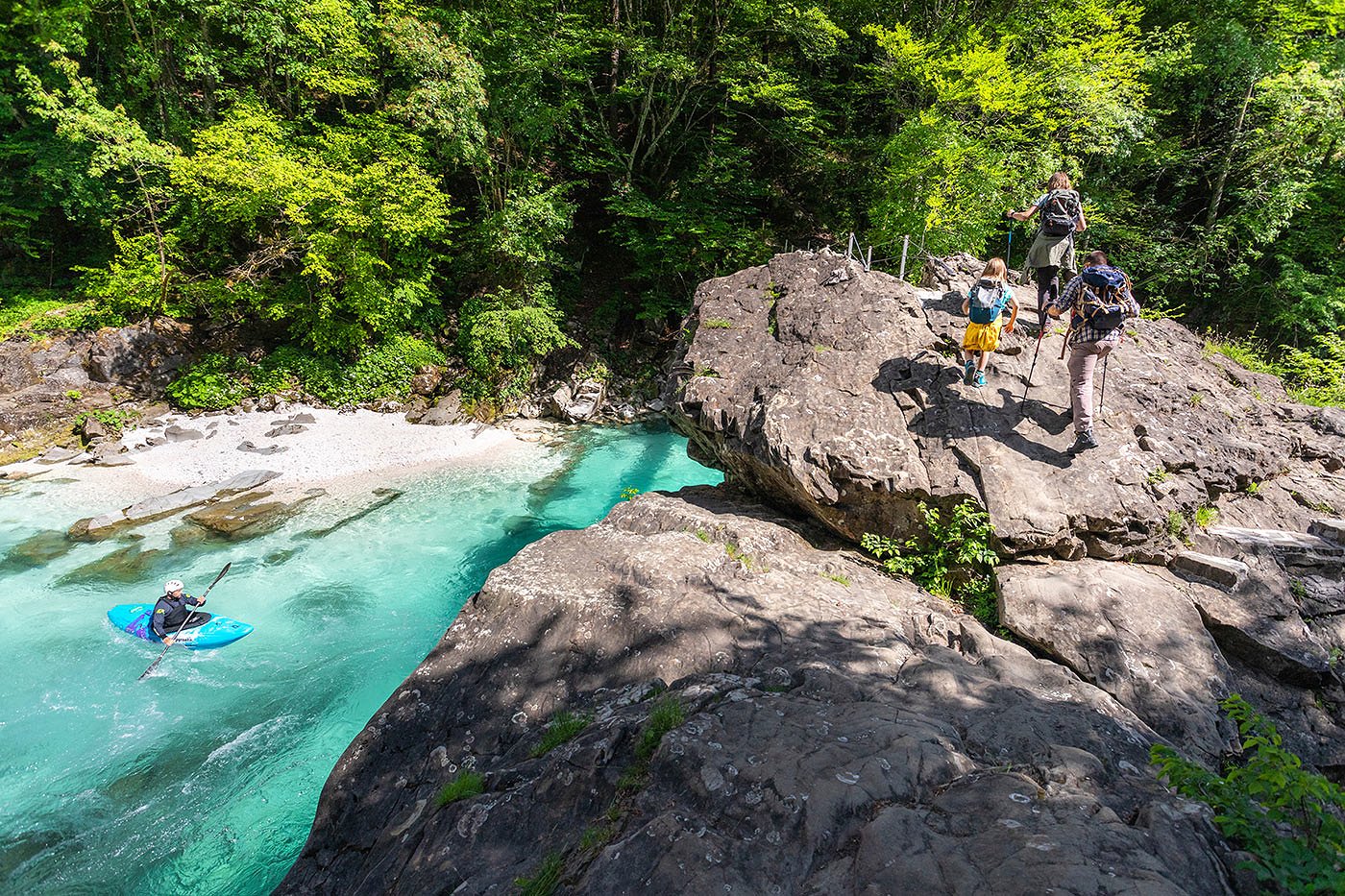 The family will cross the hanging bridge under which the kayaker will go